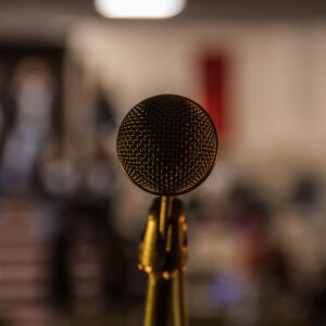 selective focus photography of brass-colored microphone