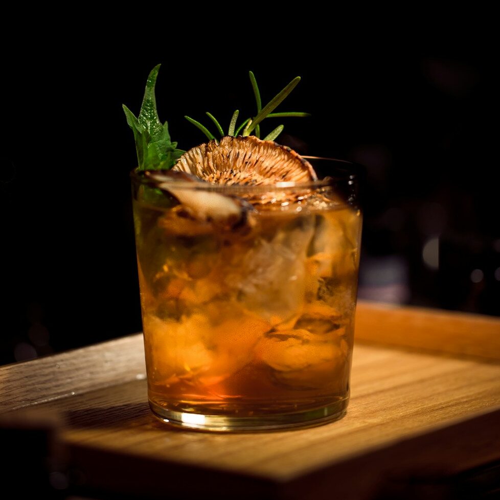 clear glass tumbler on brown wooden tray